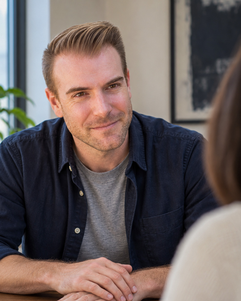 Brian Kaufman, co-founder and head of strategy at Tipping Media, listening across a wooden table.