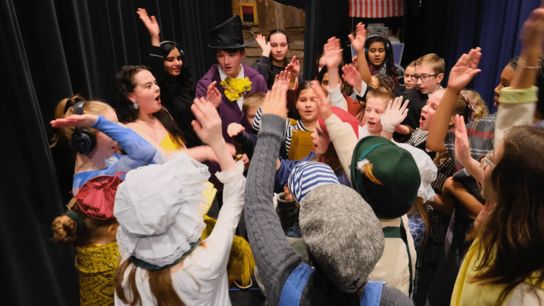 Abiqua School project image: students celebrating together backstage after a school production.